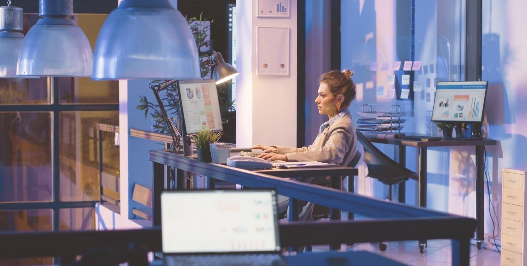 Design workspace showing mobile app wireframes, color palettes, and design tools on desk